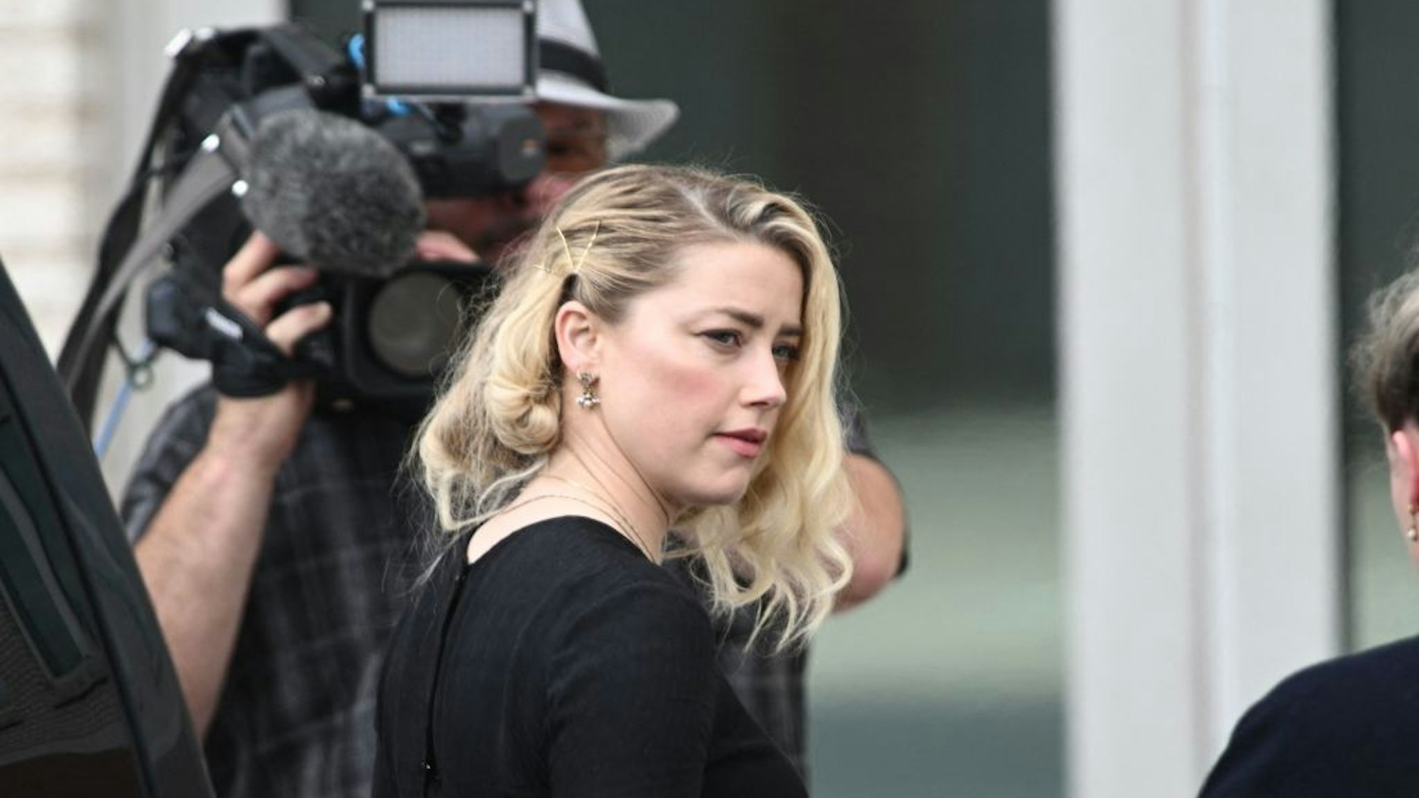 US actress Amber Heard arrives to hear the verdict in the Depp v. Heard trial at the Fairfax County Circuit Courthouse in Fairfax, Virginia, on June 1, 2022. - The jury reached a verdict on Wednesday in the high-profile defamation case between actor Johnny Depp and his ex-wife Heard. The seven-person Virginia jury has been deliberating for about 13 hours over three days in Fairfax County Circuit Court near the US capital. The court said the verdict is to be read out at 3:00 pm (1900 GMT). (Photo by Brendan SMIALOWSKI / AFP) (Photo by BRENDAN SMIALOWSKI/AFP via Getty Images)