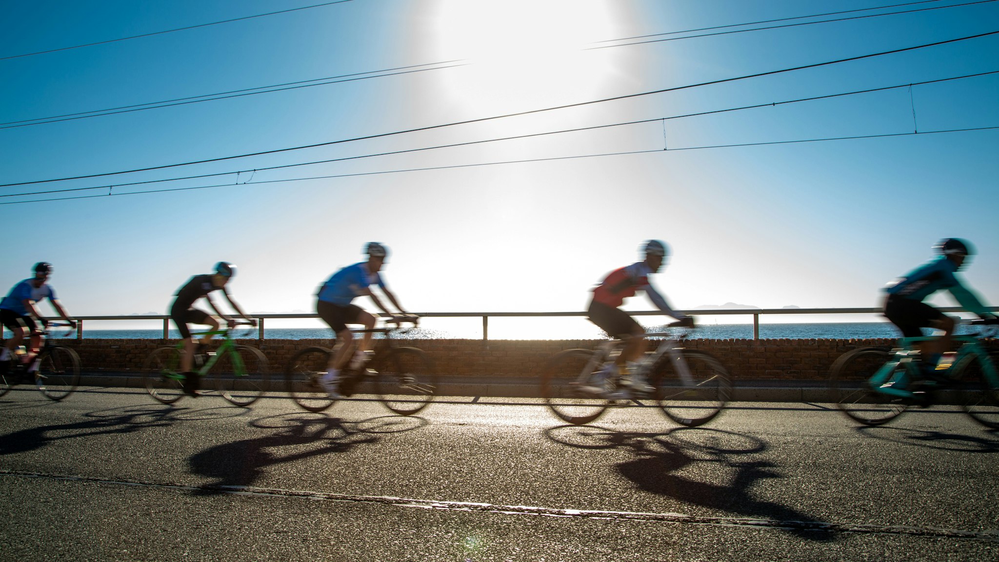 Group of blurred riders in a mass participation cycle race - stock photo