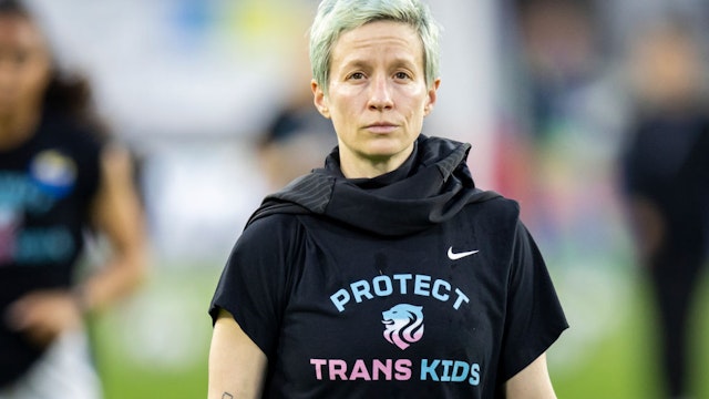 Megan Rapinoe #15 of OL Reign wears a shirt that says Protest Trans Kids while she walks back to locker room after warm ups before the 2022 NWSL Challenge Cup Semifinal match against Washington Spirit at Audi Field on May 4, 2022 in Washington, DC.