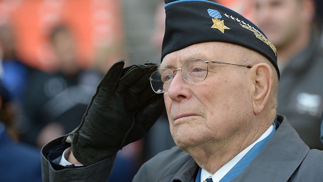 WASHINGTON, DC December 27: Medal of Honor Recipient Hershal "Woody" Williams, who achieved his recognition for his actions in the battle for Iwo Jima, saluts during the playing of the National Anthem prior to the Military Bowl on December 27, 2012 in Washington, DC (Photo by Jonathan Newton / The Washington Post via Getty Images)