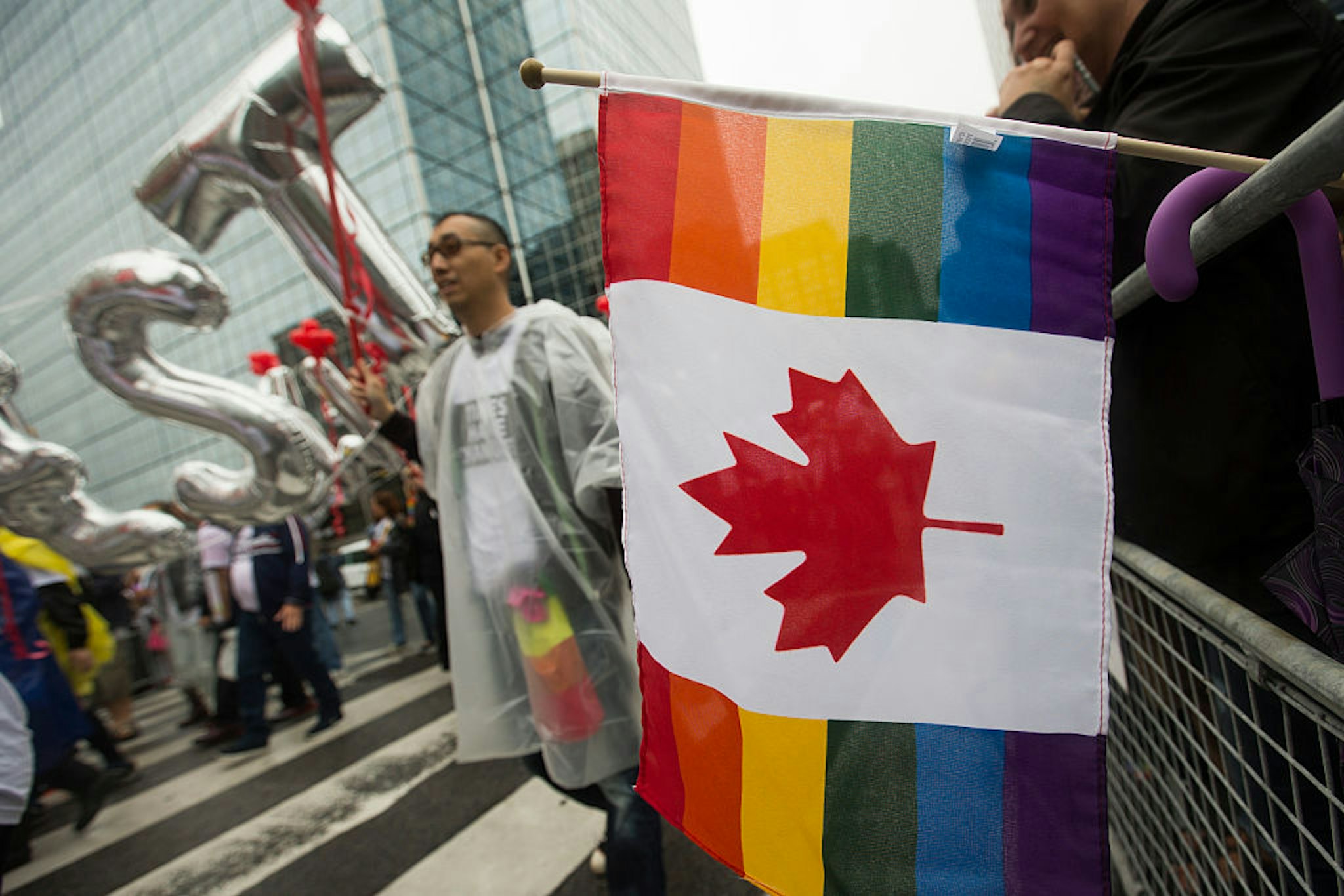 TORONTO, - JUNE 28, 2015 - A combination of a Canadian flag and a Pride flag hangs over the barrier on Bloor Street East. Toronto Pride 2015 took over the downtown core as the annual Pride Parade wound itself through the downtown. Photographed on JUNE 28, 2015. (Rick Madonik/Toronto Star via Getty Images)