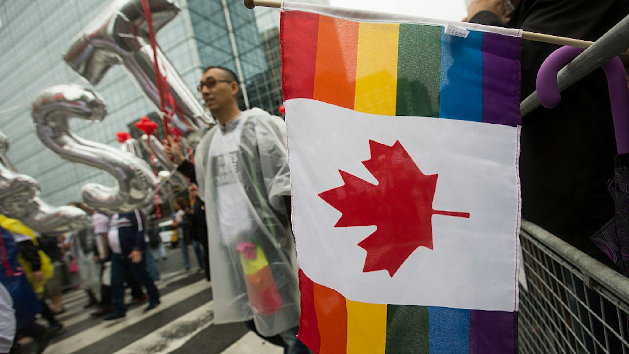 TORONTO, - JUNE 28, 2015 - A combination of a Canadian flag and a Pride flag hangs over the barrier on Bloor Street East. Toronto Pride 2015 took over the downtown core as the annual Pride Parade wound itself through the downtown. Photographed on JUNE 28, 2015. (Rick Madonik/Toronto Star via Getty Images)