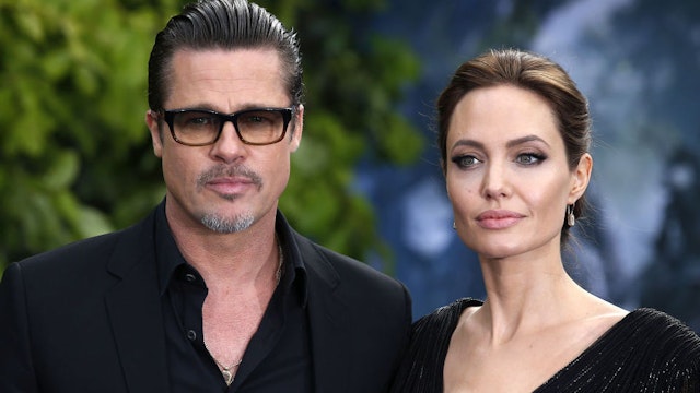Brad Pitt and Angelina Jolie attending the premiere of Maleficent at Kensington Palace, London.