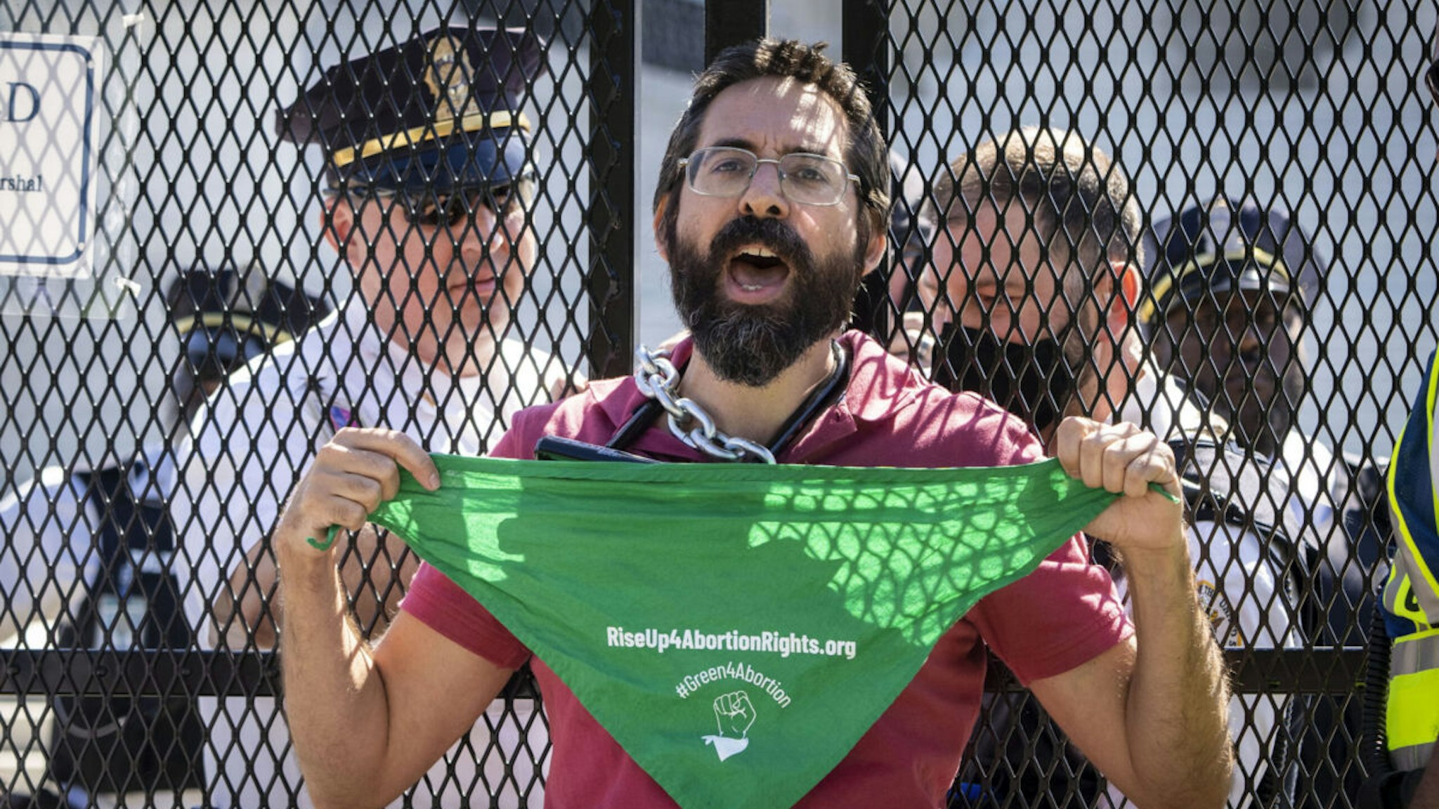 Abortion-rights activist Guido Reichstadter is confronted and detained by Supreme Court Police officers after chaining himself to a security fence in front of the U.S. Supreme Court on June 6, 2022 in Washington, DC.