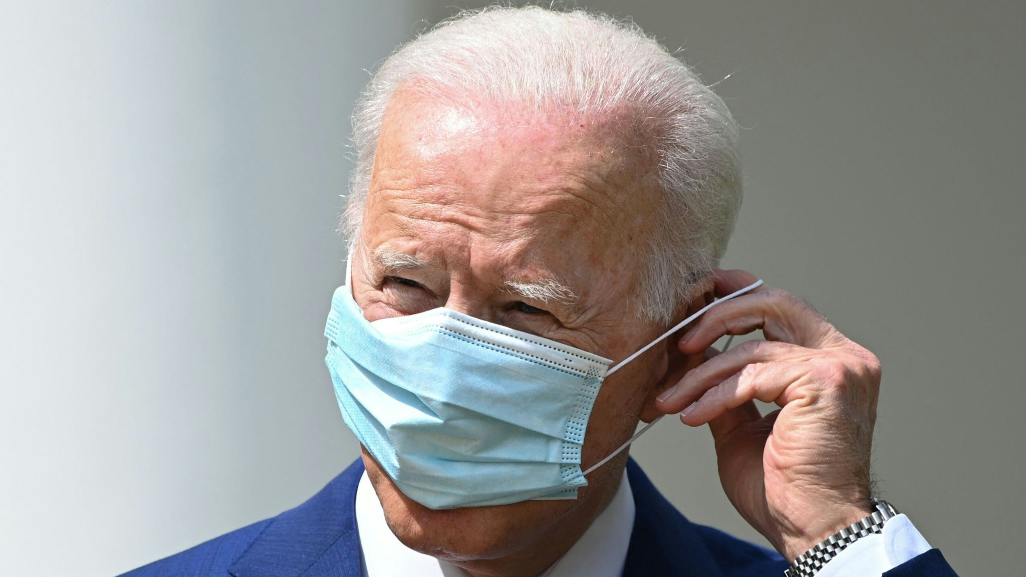 US President Joe Biden puts on his mask after speaking during an event about gun violence prevention in the Rose Garden of the White House in Washington, DC, on April 8, 2021. - Biden on Thursday called US gun violence an "epidemic" at a White House ceremony to unveil new attempts to get the problem under control.