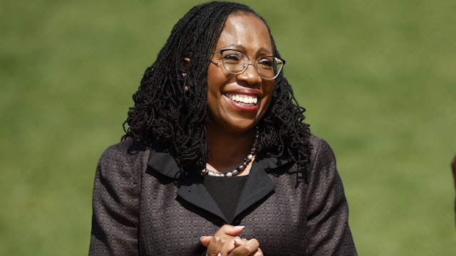 WASHINGTON, DC - APRIL 08: Judge Ketanji Brown Jackson smiles as Vice President Kamala Harris speaks at an event celebrating her confirmation to the U.S. Supreme Court on the South Lawn of the White House on April 08, 2022 in Washington, DC. Judge Jackson was confirmed by the Senate 53-47 and is set to become the first Black woman to sit on the nation's highest court.
