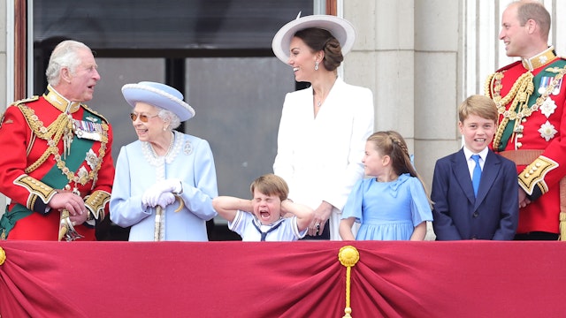 Queen Elizabeth II smiles on the balcony of Buckingham Palace during Trooping the Colour alongside (L-R) Camilla, Duchess of Cornwall, Prince Charles, Prince of Wales, Prince Louis of Cambridge, Catherine, Duchess of Cambridge, Princess Charlotte of Cambridge, Prince George of Cambridge and Prince William, Duke of Cambridge during Trooping The Colour on June 02, 2022 in London, England.