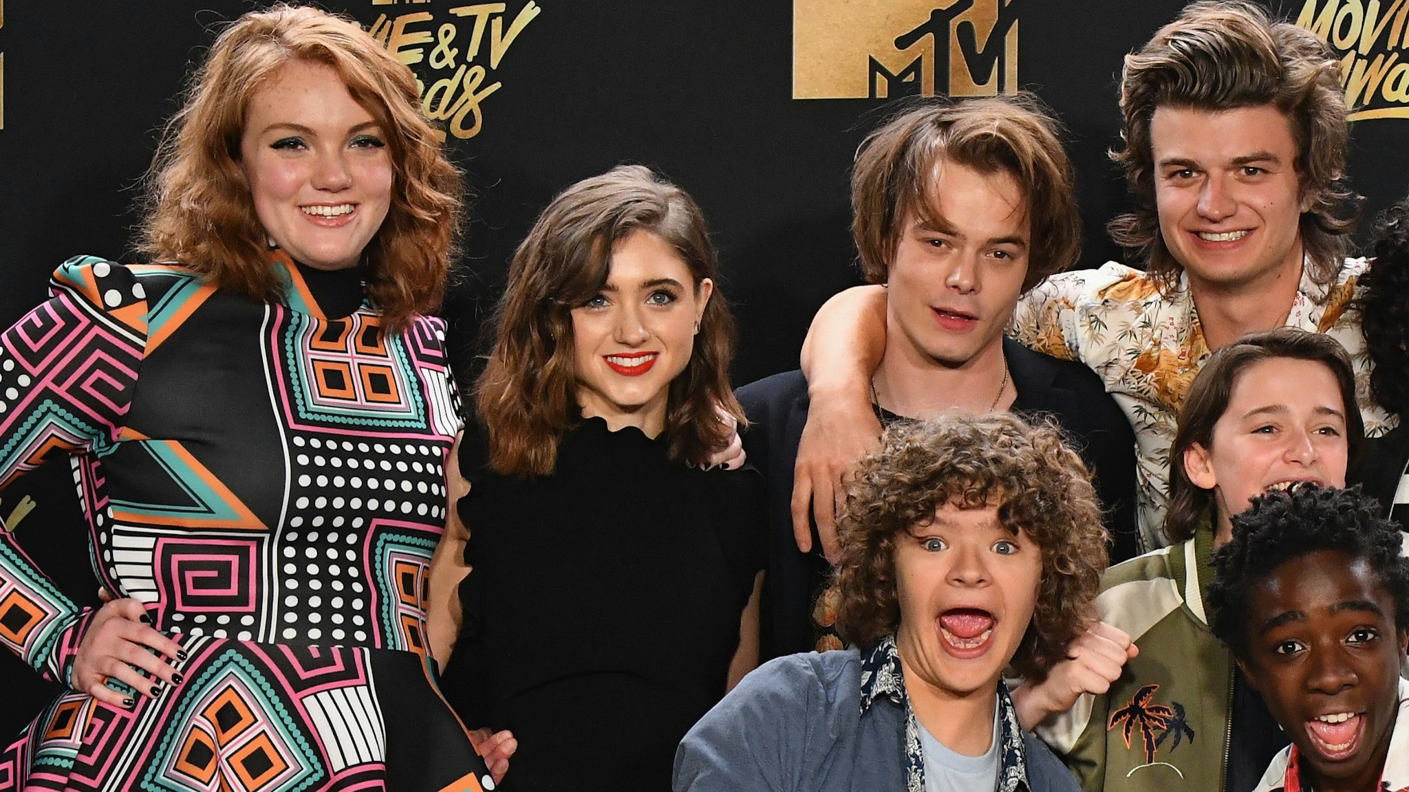 Actors Shannon Purser, Natalia Dyer, Charlie Heaton, Joe Keery, (middle, L-R) Noah Schnapp, Finn Wolfhard, Millie Bobby Brown, and (front L-R) Gaten Matarazzo and Caleb McLaughlin of 'Stranger Things,' winner of the Show of the Year award, pose in the press room during the 2017 MTV Movie And TV Awards at The Shrine Auditorium on May 7, 2017 in Los Angeles, California.