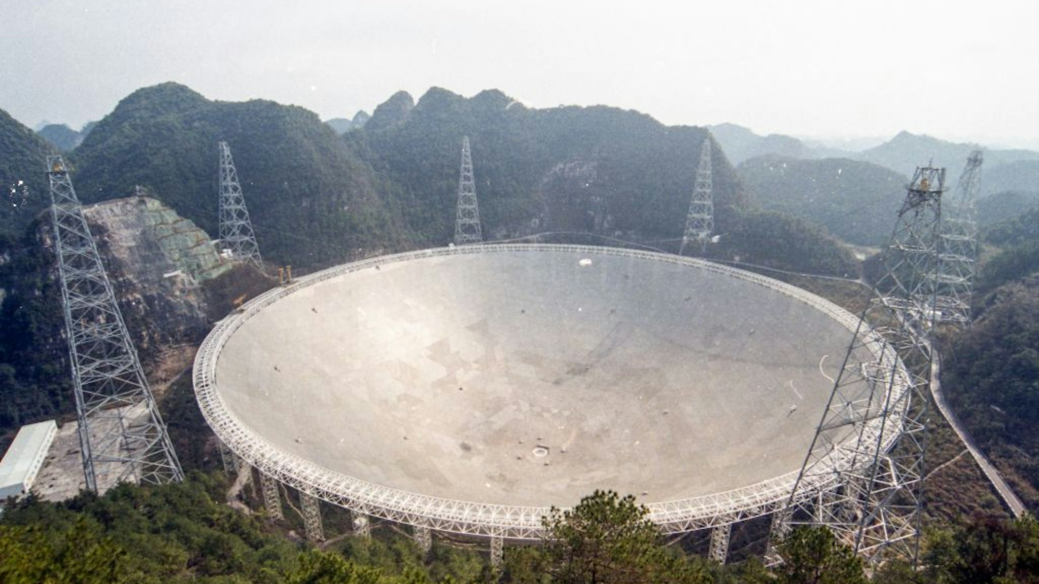 QIANNAN, CHINA - FEBRUARY 07: Aerial view of the Five-hundred-meter Aperture Spherical radio Telescope (FAST) at Pingtang County on February 7, 2021 in Qiannan Buyei and Miao Autonomous Prefecture, Guizhou Province of China. The 500-meter aperture spherical radio telescope (FAST), also known as China's 'Sky Eye', will open to global scientific community from April 1.