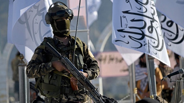 A Taliban fighter stands guard at the venue for a flag hoisting ceremony of the Taliban flag on the Wazir Akbar Khan hill in Kabul on March 31, 2022