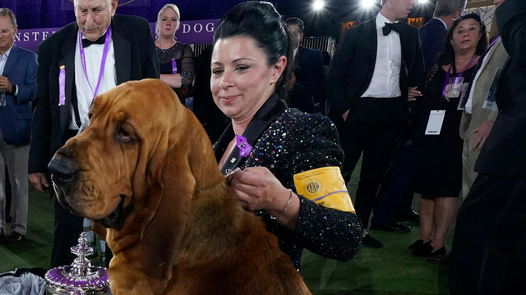 Trumpet the bloodhound poses with breeder and handler Heather Buehner after winning Best in Show at the 146th Westminster Kennel Club Dog Show at the Lyndhurst Mansion, in Tarrytown, New York, on June 22, 2022.