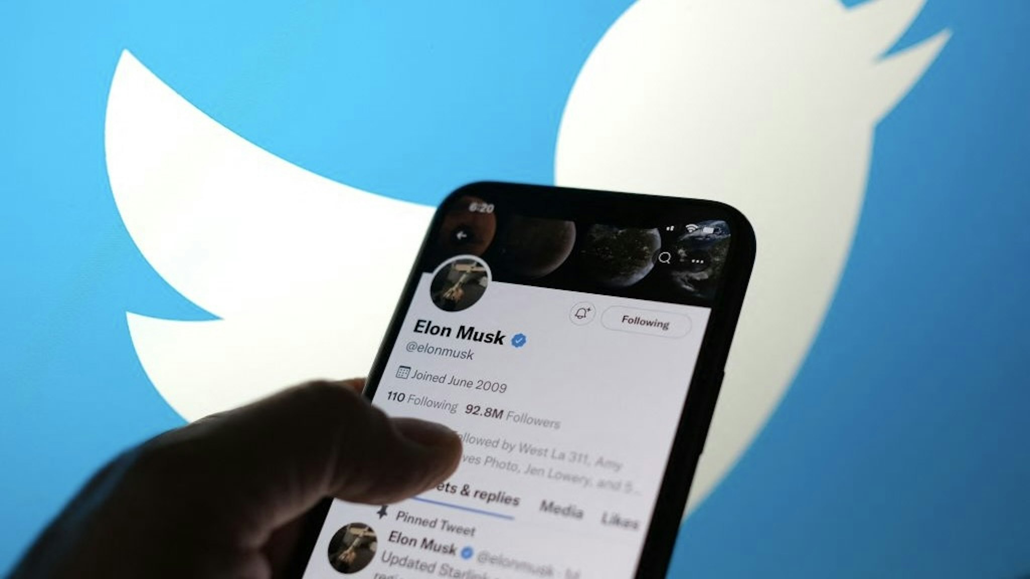 This illustration photo taken May 13, 2022, displays Elon Musks Twitter account with a Twitter logo in the background in Los Angeles.