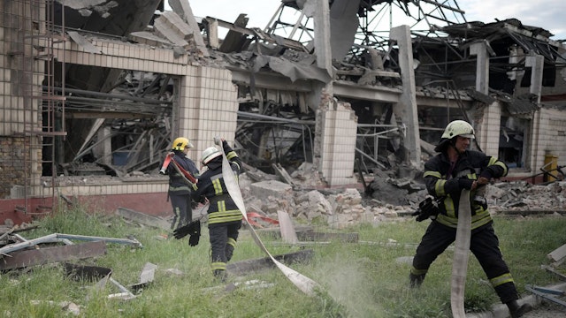 Firefighters continue to dampen down a rail freight rolling stock repair facility in Darnytsia district ​after a Russian air strikeon June 05, 2022 in Kyiv, Ukraine.