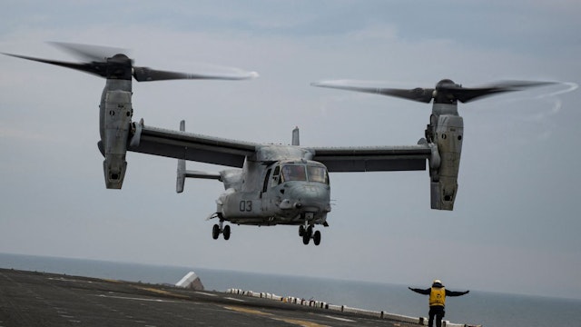 An Aviation Boatswains Mate signals to the pilots of an MV-22 Osprey assault support aircraft, assigned to the 22nd Marine Expeditionary Unit, as it approaches to land on the flight deck of the Wasp-class amphibious assault ship USS Kearsarge (LHD 3) on June 7, 2022, during the BALTOPS 22 Exercise in the Baltic Sea.