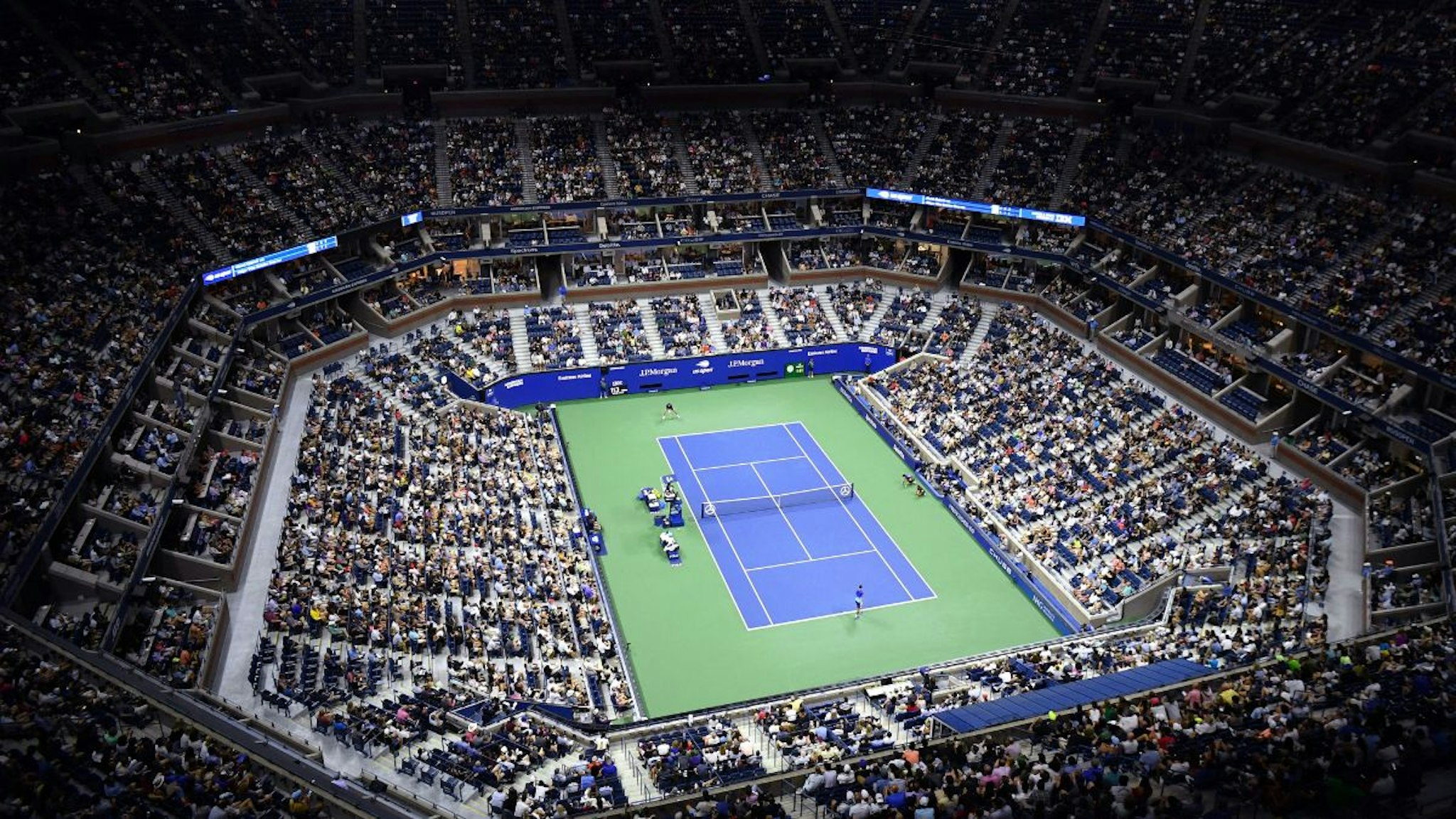 An overview shows Arthur Ashe Stadium during the 2021 US Open Tennis tournament men's singles first round match between Serbia's Novak Djokovic (bottom) and Denmark's Holger Rune at the USTA Billie Jean King National Tennis Center in New York, on August 31, 2021.