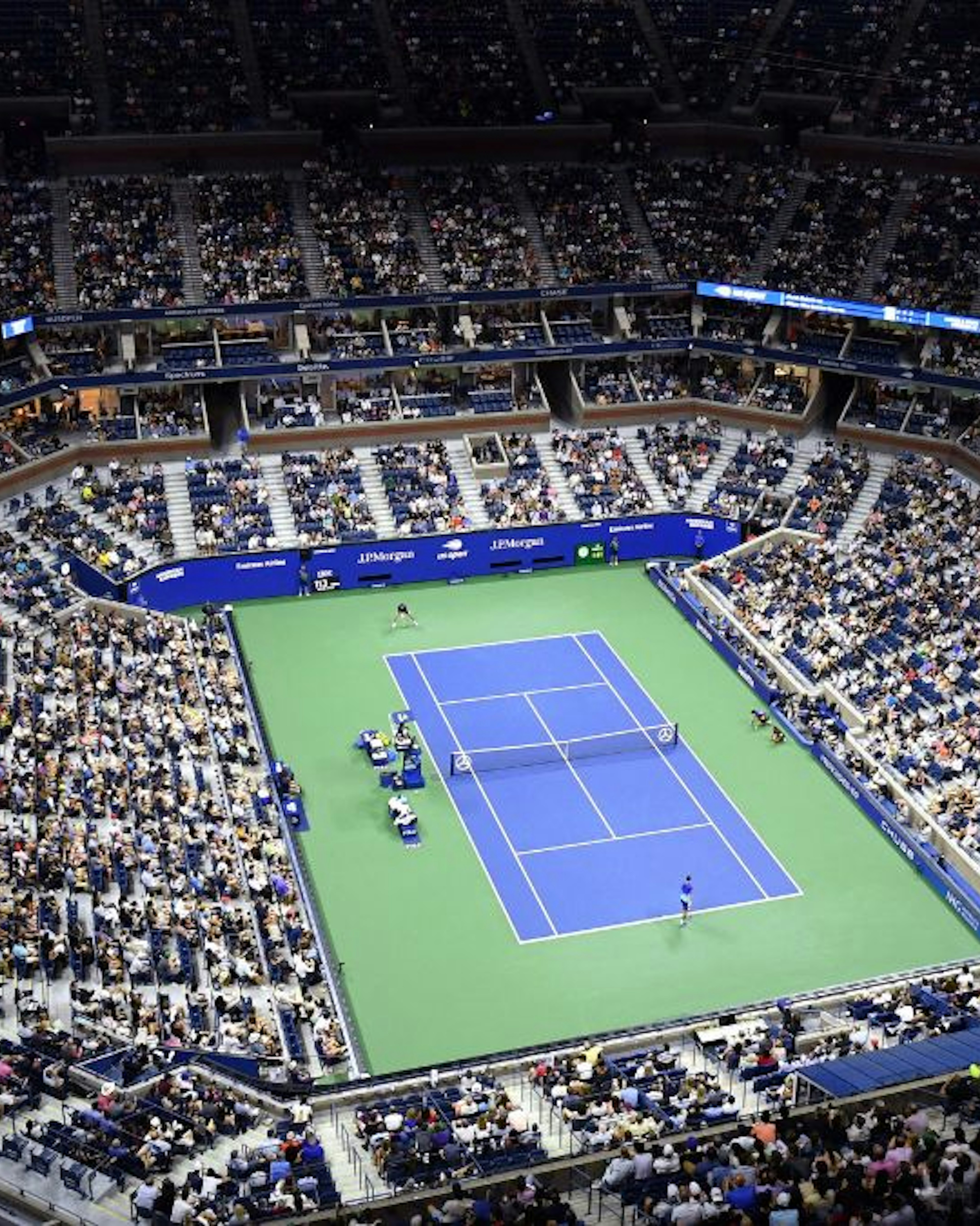 An overview shows Arthur Ashe Stadium during the 2021 US Open Tennis tournament men's singles first round match between Serbia's Novak Djokovic (bottom) and Denmark's Holger Rune at the USTA Billie Jean King National Tennis Center in New York, on August 31, 2021.