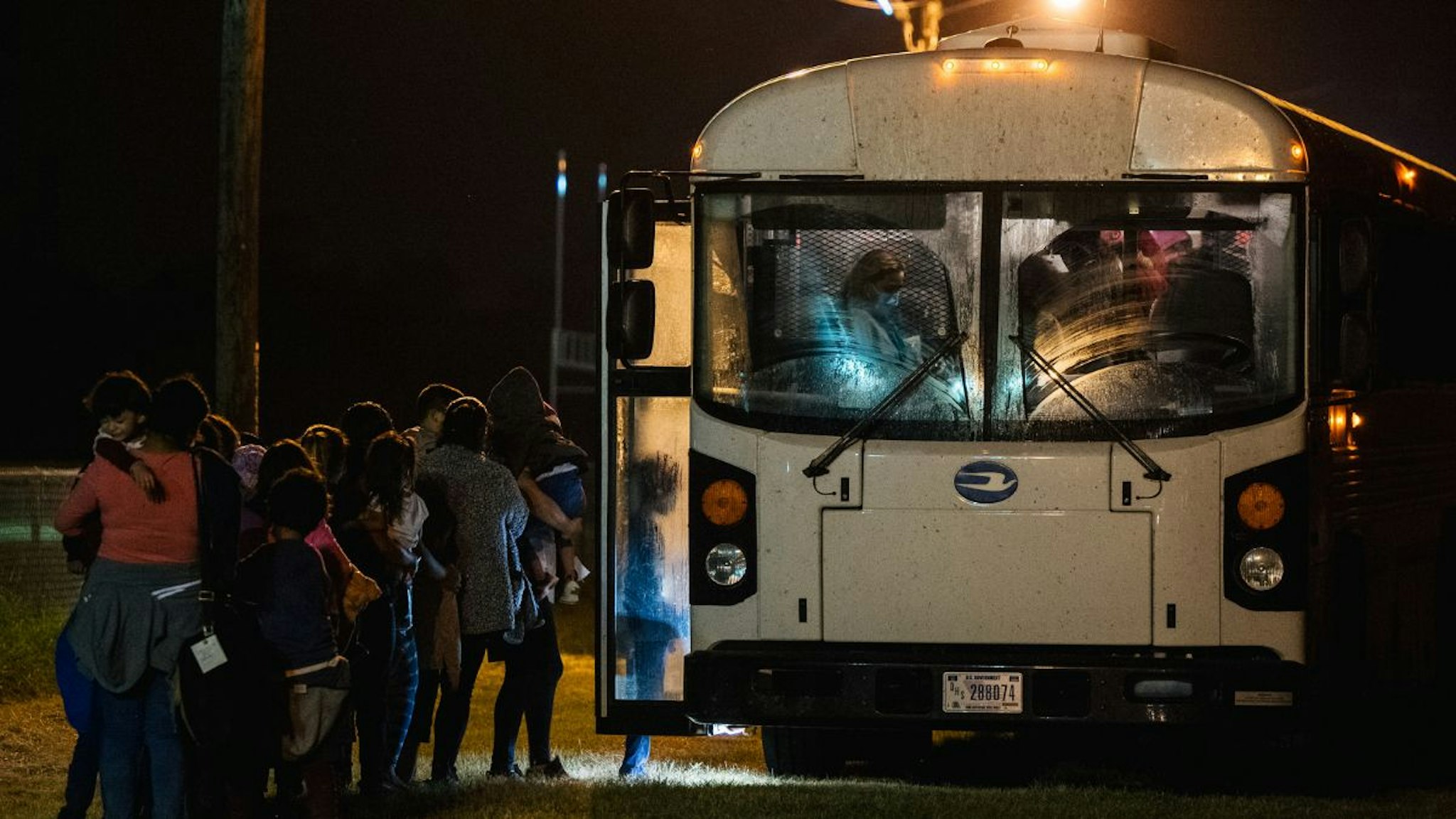 Migrants board a bus to be taken to a border patrol processing facility after crossing the Rio Grande into the U.S. on June 21, 2021 in La Joya, Texas.