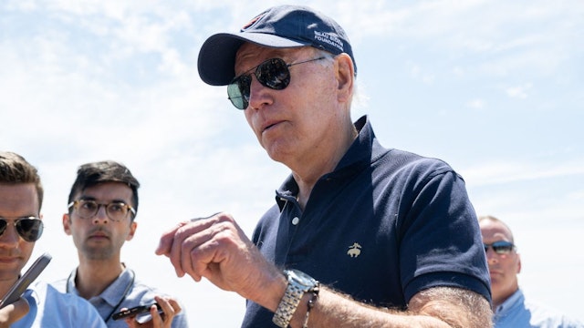 US President Joe Biden speaks with reporters as he walks on the beach in Rehoboth Beach, Delaware, June 20, 2022.