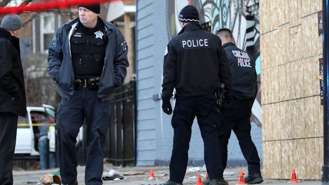Police investigate at the scene of a shooting in the 4000 block of West 26th Street Saturday, Jan. 22, 2022, in Chicago.