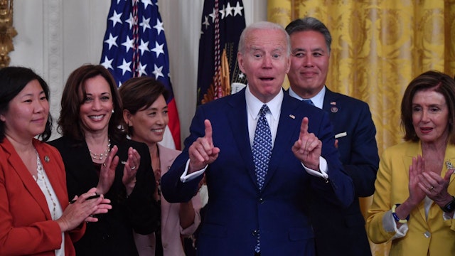 US President Joe Biden gestures during a bill signing ceremony for a legislation to establish a commission to study the creation of a National Museum of Asian American History, in the East Room of the White House on June 13, 2022 in Washington, DC.