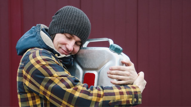 Stock photo: Young Adult Man Trying To Refuel Car And Happy To Find Benzine Canister During His Road Trip.