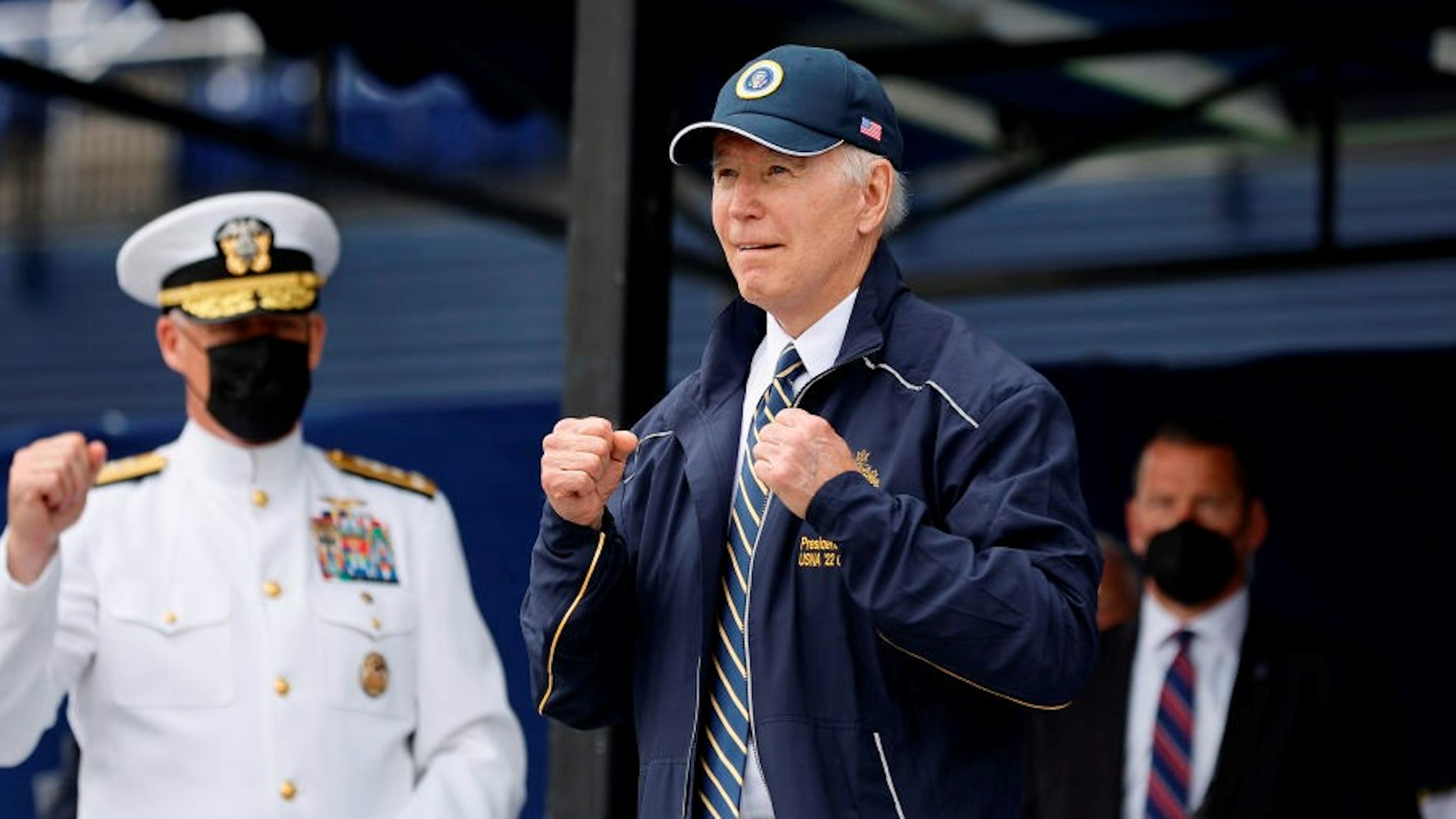 ANNAPOLIS, MARYLAND - MAY 27: U.S. President Joe Biden shows off the jacket and hat he received as a gift from the graduating class of the U.S. Naval Academy at the conclusion of the graduation and commissioning ceremony in Memorial Stadium on May 27, 2022 in Annapolis, Maryland. a total of 1,100 sailors and Marines graduated from the service academy. (Photo by