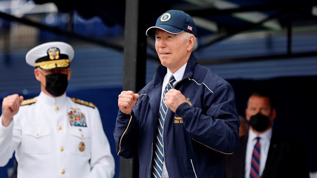 ANNAPOLIS, MARYLAND - MAY 27: U.S. President Joe Biden shows off the jacket and hat he received as a gift from the graduating class of the U.S. Naval Academy at the conclusion of the graduation and commissioning ceremony in Memorial Stadium on May 27, 2022 in Annapolis, Maryland. a total of 1,100 sailors and Marines graduated from the service academy. (Photo by