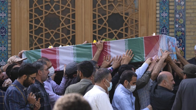 Iranian mourners carrying the coffin containing the body of the Islamic Revolutionary Guard Corps' (IRGC) colonel, Sayyad Khodai, during Khodais funeral in a mosque in southern Tehran on May 24, 2022. Colonel Sayyad Khodai of the Islamic Revolutionary Guard Corps (IRGC) was shot dead in front of his home on May 22 by motorbike assassins in Tehran.