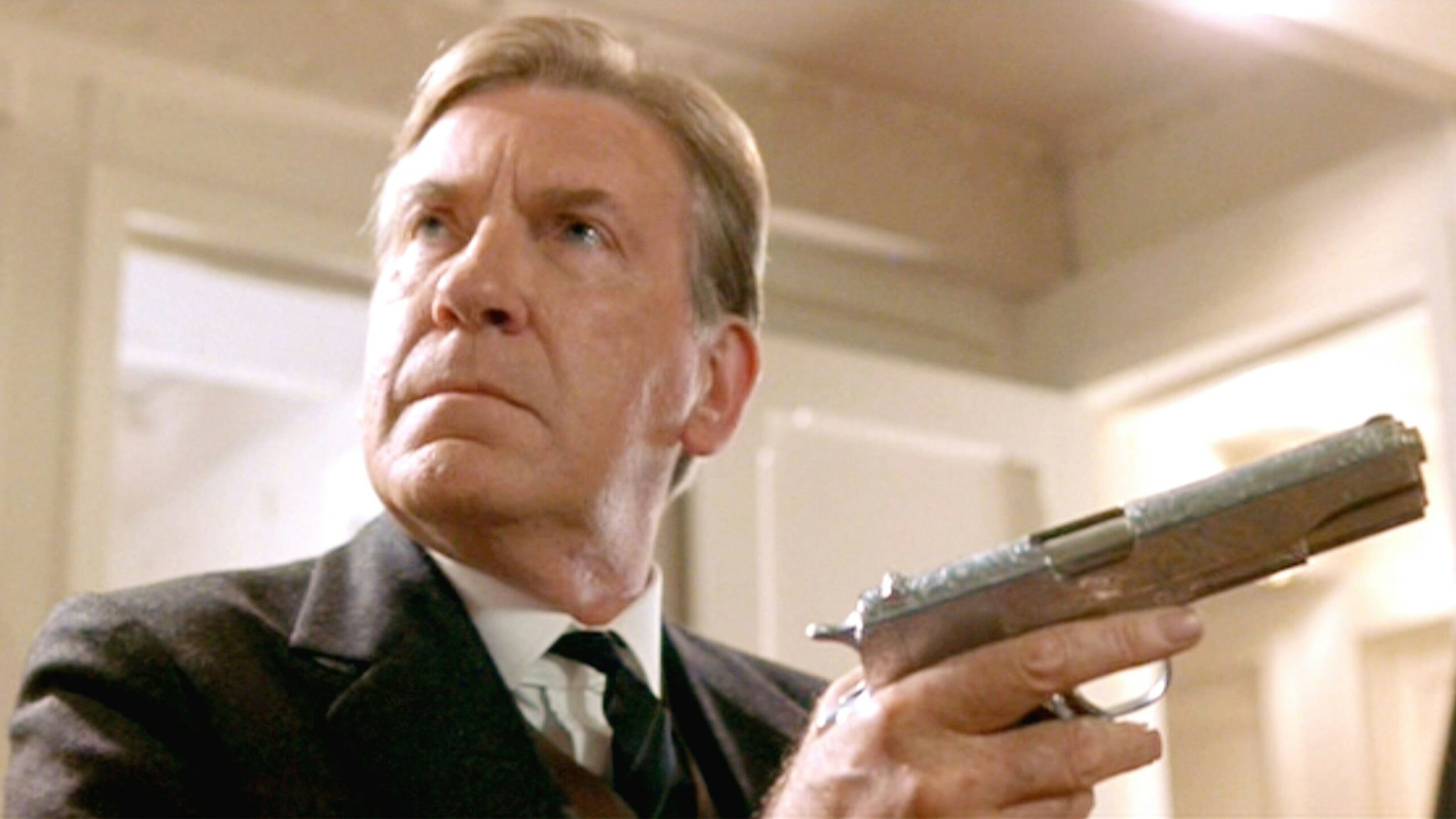 LOS ANGELES - DECEMBER 19: The movie "Titanic", written and directed by James Cameron. Seen here, David Warner as Spicer Lovejoy with an M1911 pistol. Initial USA theatrical wide release December 19, 1997. Screen capture. Paramount Pictures.