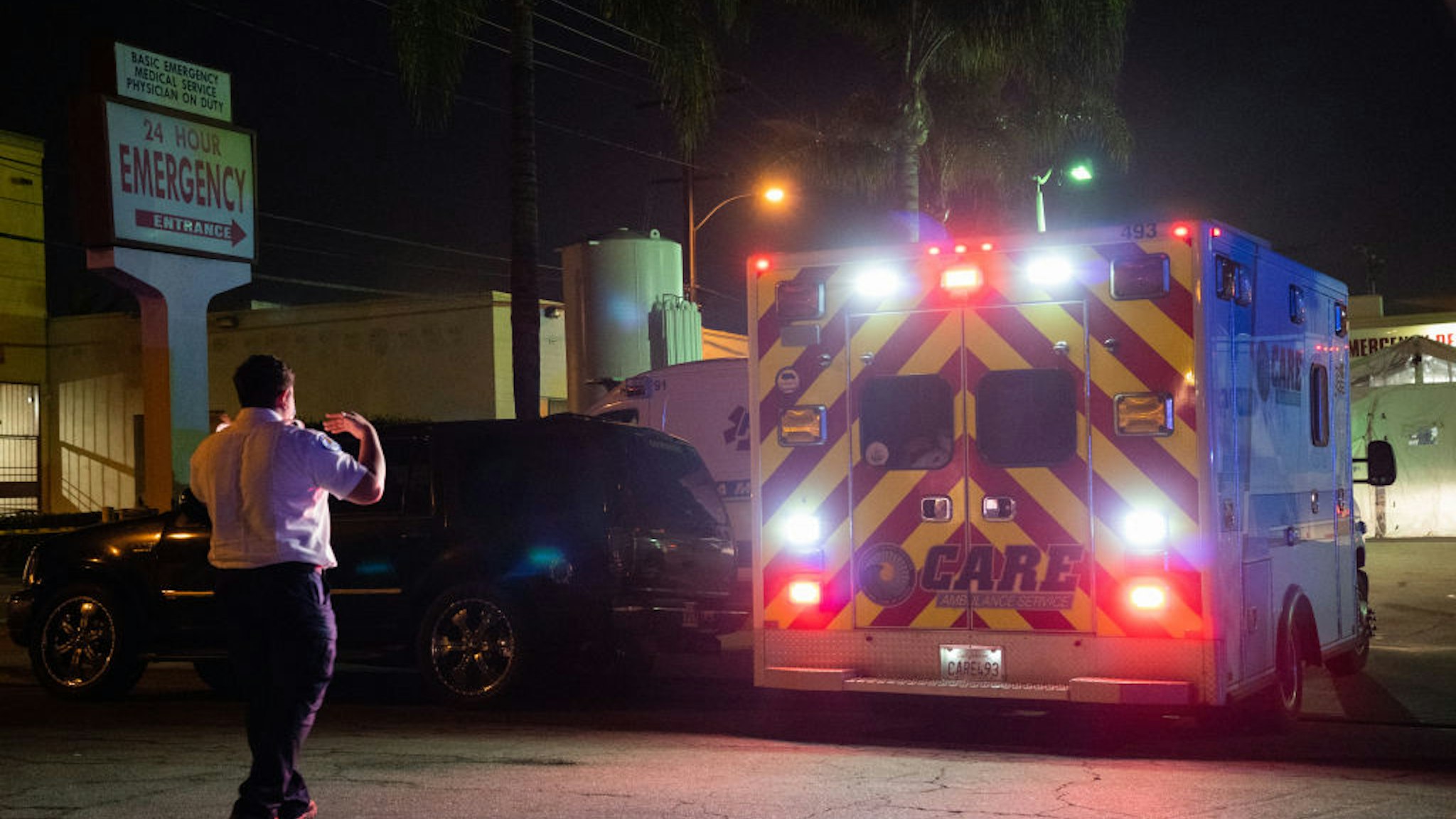An emergency medical technician (EMT) directs an ambulance outside the emergency room of the East Los Angeles Doctors Hospital in Los Angeles, California, U.S., on Wednesday, Jan. 6, 2021. California reported 459 daily virus deaths, the second-highest tally since the pandemic began, as the most-populous state continues to battle a surge of cases that has strained health-care facilities. Photographer: Bing Guan/Bloomberg via Getty Images