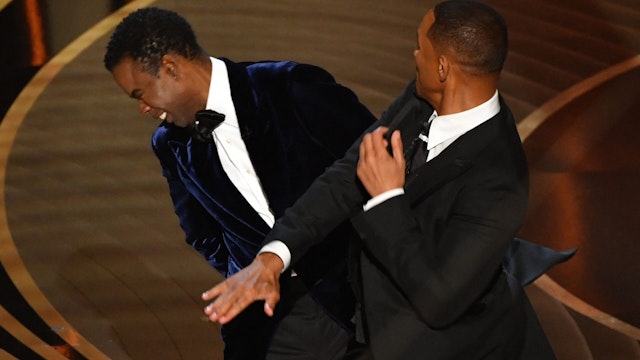 TOPSHOT - US actor Will Smith (R) slaps US actor Chris Rock onstage during the 94th Oscars at the Dolby Theatre in Hollywood, California on March 27, 2022
