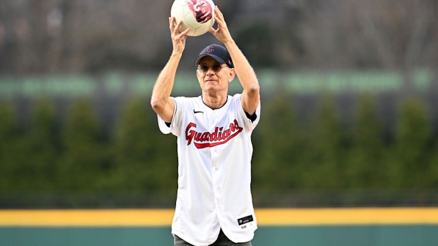 CLEVELAND, OHIO - APRIL 15: Actor and Cleveland Guardians fan Tom Hanks holds his co-star Wilson before throwing out the ceremonial first pitch prior to the home opener against the San Francisco Giants at Progressive Field on April 15, 2022 in Cleveland, Ohio. All players are wearing the number 42 in honor of Jackie Robinson Day. (Photo by Jason Miller/Getty Images)