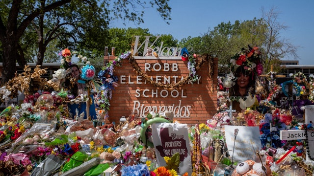 UVALDE, TEXAS - JUNE 17: The Robb Elementary School sign is seen covered in flowers and gifts on June 17, 2022 in Uvalde, Texas. Committees have begun inviting testimony from law enforcement authorities, family members and witnesses regarding the mass shooting at Robb Elementary School which killed 19 children and two adults. Because of the quasi-judicial nature of the committee's investigation and pursuant to House, Section 12, witnesses will be examined in executive session. (Photo by Brandon Bell/Getty Images)