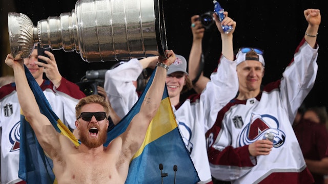 DENVER, COLORADO - JUNE 30: Gabriel Landeskog #92 of the Colorado Avalanche lifts the Stanley Cup on-stage during the Colorado Avalanche Victory Parade and Rally at Civic Center Park on June 30, 2022 in Denver, Colorado. (Photo by Matthew Stockman/Getty Images)