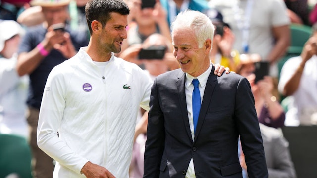 Novak Djokovic (L) of Serbia greet with John McEnroe during the Centre Court Centenary Celebration during day seven of The Championships Wimbledon 2022 at All England Lawn Tennis and Croquet Club on July 03, 2022 in London, England.