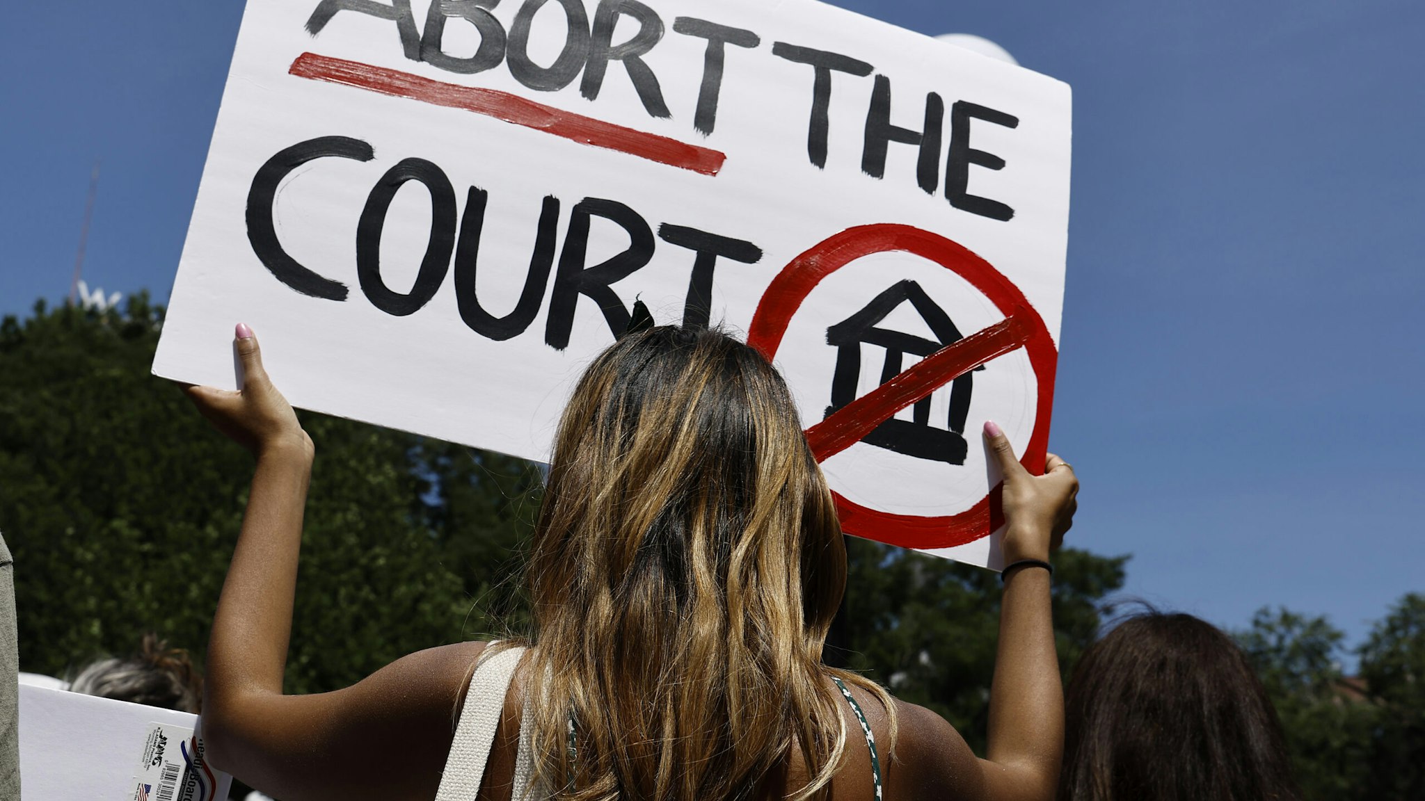 NEW YORK, NEW YORK - JULY 04: A woman holds up a sign in Union Square during a demonstration against the Supreme Court on July 4, 2022 in New York City. The Supreme Court's June 24th decision in the Dobbs v Jackson Women's Health case overturned the landmark 50-year-old Roe v Wade case, removing a federal right to an abortion. Many states enacted “Trigger Laws” immediately following the decision while others filed suits to retain their right to continue performing abortions. The ruling imposed legal restrictions following the first trimester of the pregnancy and clearing the way for states to set their own laws. (Photo by John Lamparski/Getty Images)