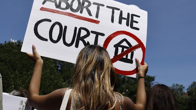 NEW YORK, NEW YORK - JULY 04: A woman holds up a sign in Union Square during a demonstration against the Supreme Court on July 4, 2022 in New York City. The Supreme Court's June 24th decision in the Dobbs v Jackson Women's Health case overturned the landmark 50-year-old Roe v Wade case, removing a federal right to an abortion. Many states enacted “Trigger Laws” immediately following the decision while others filed suits to retain their right to continue performing abortions. The ruling imposed legal restrictions following the first trimester of the pregnancy and clearing the way for states to set their own laws. (Photo by John Lamparski/Getty Images)