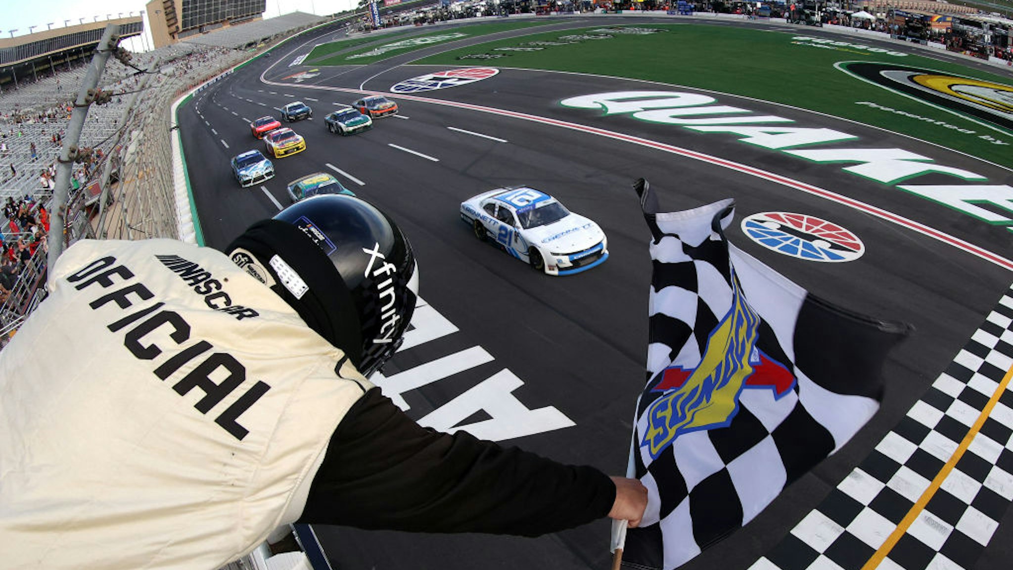 Austin Hill, driver of the #21 Bennett Transportation and Logistics Chevrolet, takes the checkered flag to win the NASCAR Xfinity Series Alsco Uniforms 250 at Atlanta Motor Speedway on July 09, 2022 in Hampton, Georgia.