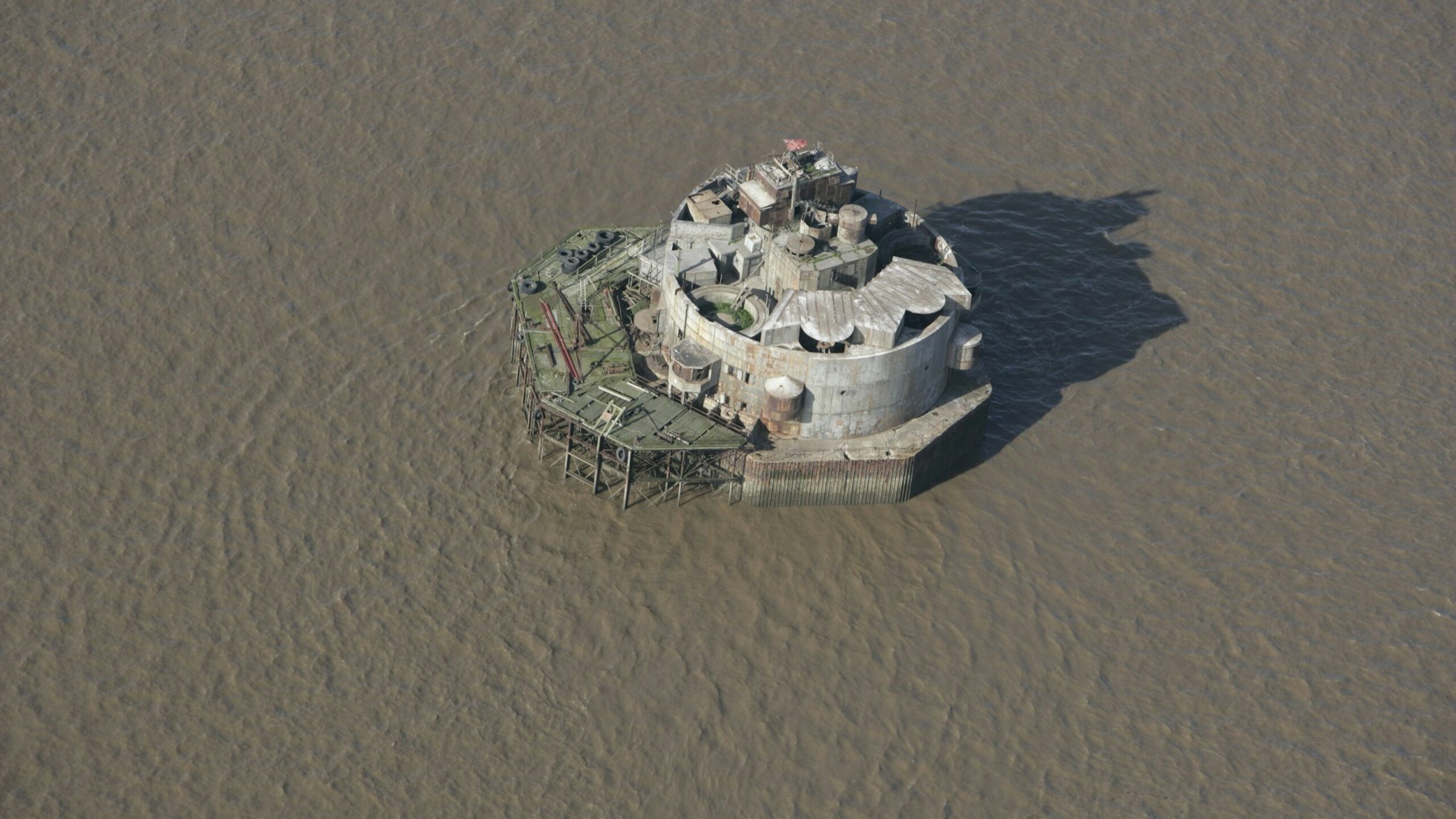 Bull Sand Fort, Humber Estuary, 2006. Aerial view. Standing one and a half miles from shore off Spurn Head on a submerged sandbank, it stands 18 metres high and 25metres in diameter. Bull Sand Fort and its twin Haile Sand Fort were built in 1914 to protect the mouth of the Humber from enemy attack. They were completed just as the First World War broke out. They were also used in the Second World War as anti-aircraft and anti-submarine defences. Artist: Historic England Staff Photographer.