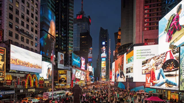 New huge video displays on Times Square at dusk.