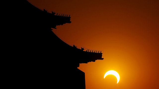 BEIJING - JANUARY 15: The moon begins to obstruct the view of the sun from earth during a soloar eclipse at the Tian'anmen Square on January 15, 2010 in Shenyang, Liaoning Province of China. The eclipse, which first became visible in Tamil Nadu city of Kanyakumari, is predicted to be the longest of its kind for the next 1000 years. (Photo by