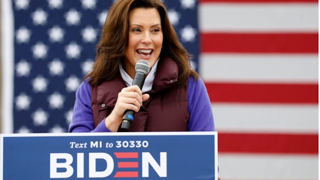 Michigan Governor Gretchen Whitmer talks with people as Democratic vice presidential nominee Senator Kamala Harris (D-CA) takes part in a campaign stop at IBEW Local 58 on October 25, 2020 in Detroit, Michigan.