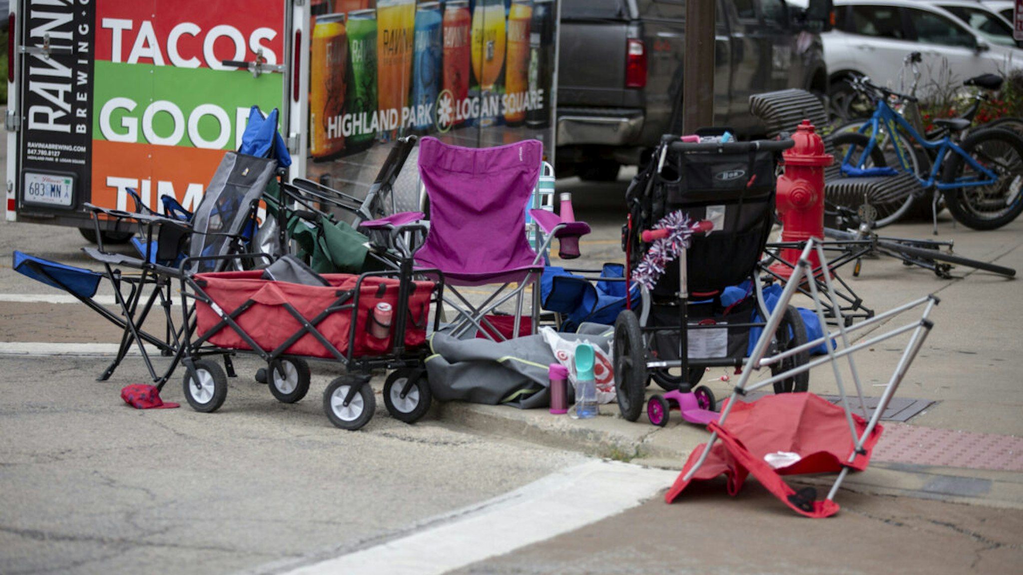 Seats used by parade watchers are left abandoned at the scene after a mass shooting at a Fourth of July parade on July 4, 2022 in Highland Park, Illinois. Reports indicate at least six people were killed and more than 20 injured in the shooting