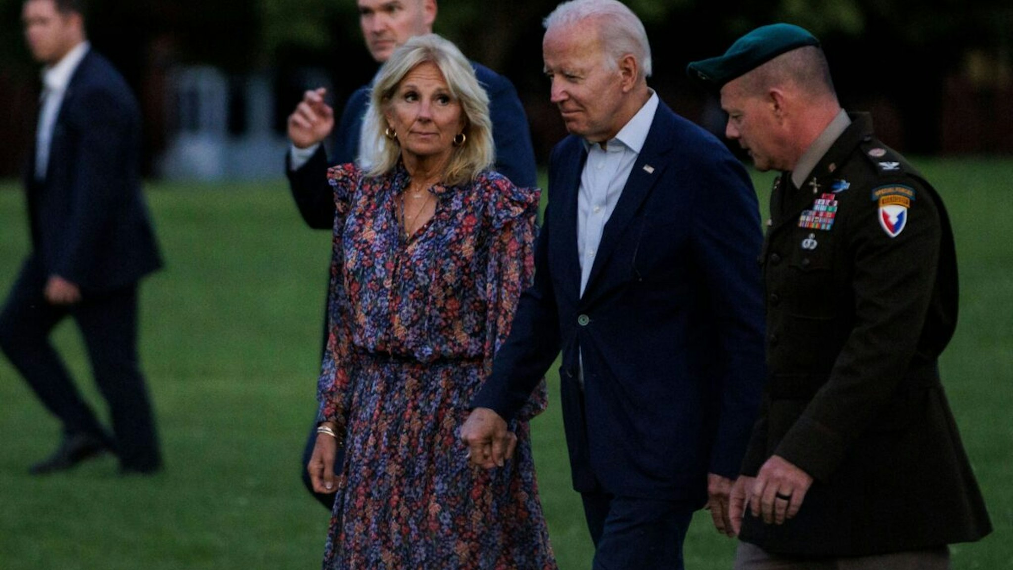 US President Joe Biden (C) and First Lady Jill Biden (L) are escorted to their vehicle by US Army Col. David Bowling at Fort McNair in Washington, DC, after spending the weekend at their vacation home in Rehoboth, Delaware on July 10, 2022.