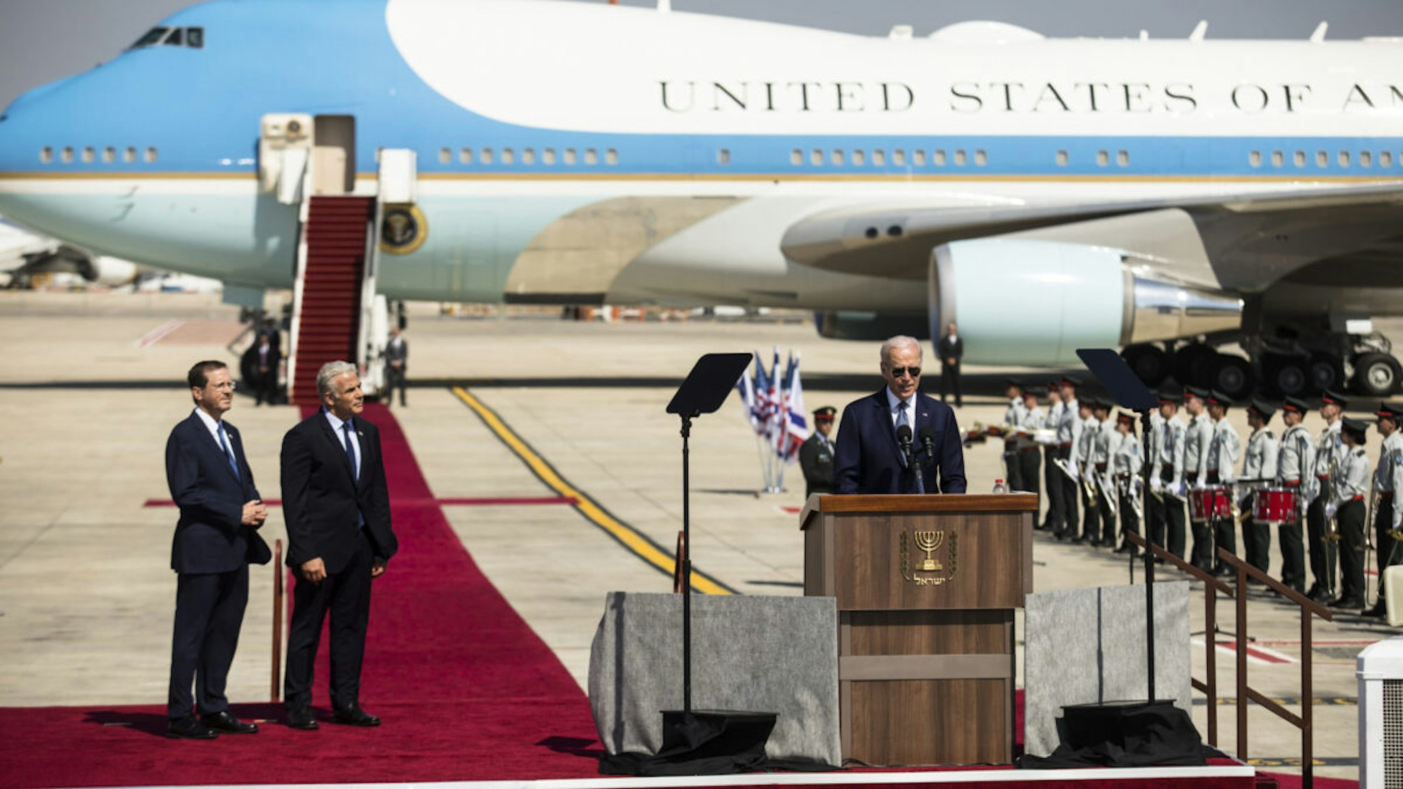 U.S. President Joe Biden speaks during the welcome ceremony as Israeli Prime Minister Yair Lapid and Israeli President Isaac Herzog listen during Biden's visit to Israel on July 13, 2022 in Lod, Israel