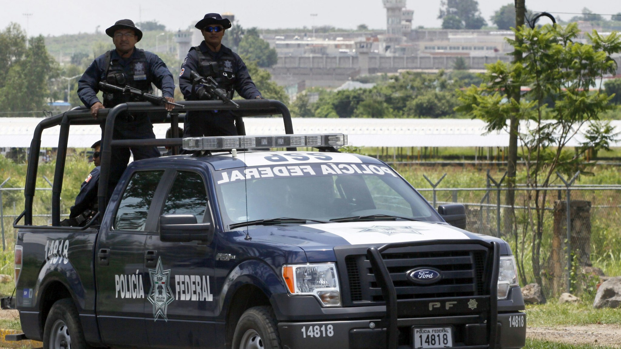 A unit of the Mexican Federal Police patrols the surroundings of the Puente Grande State prison (background) in Zapotlanejo, Jalisco State, Mexico, on 9 August, 2013 where former top Mexican cartel boss Rafael Caro Quintero -- who masterminded the kidnap and murder of a US anti-drug agent in 1985 -- was informed early Friday that a court ordered his release. A criminal court in the western state of Jalisco approved Rafael Caro Quintero's release on August 7, a court official who asked not to be identified told AFP. Caro Quintero has served 28 years in prison for the 1985 murder of US Drug Enforcement Administration special agent Enrique Camarena, who was kidnapped in Guadalajara and tortured and murdered.