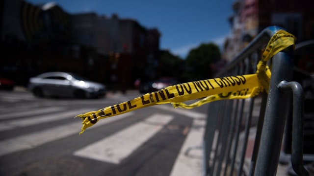 Police tape hangs from a barricade at the corner of South and 3rd Streets in Philadelphia, Pennsylvania, on June 5, 2022, the day after three people were killed and 11 others wounded by gunfire all within a few blocks. - Three people were killed and 11 others wounded late on June 4, 2022, in the US city of Philadelphia after multiple shooters opened fire into a crowd on a busy street, police said. (Photo by Kriston Jae Bethel / AFP) (Photo by KRISTON JAE BETHEL/AFP via Getty Images)