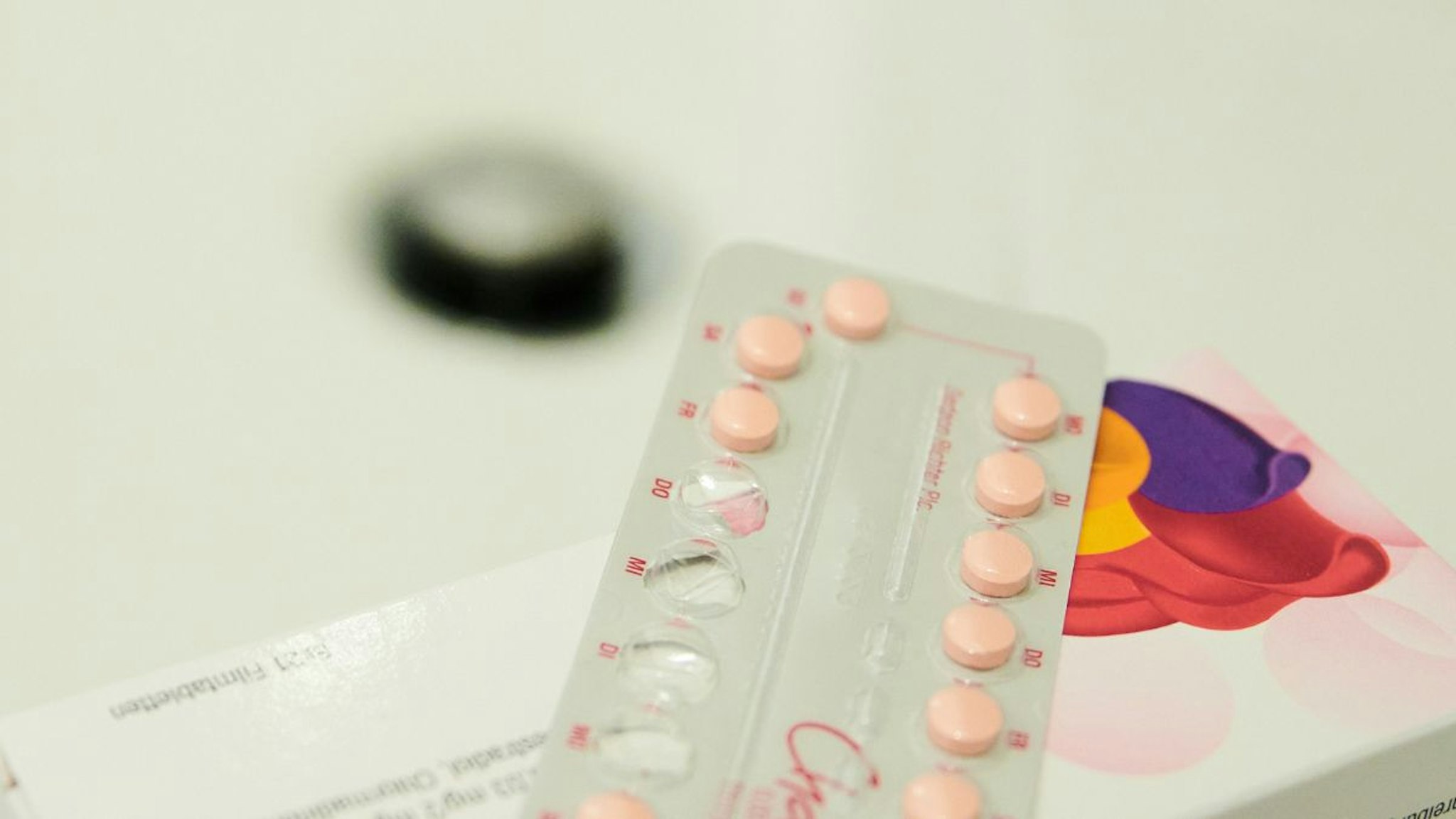 A partially opened monthly pack of the contraceptive pill lies on a sink.