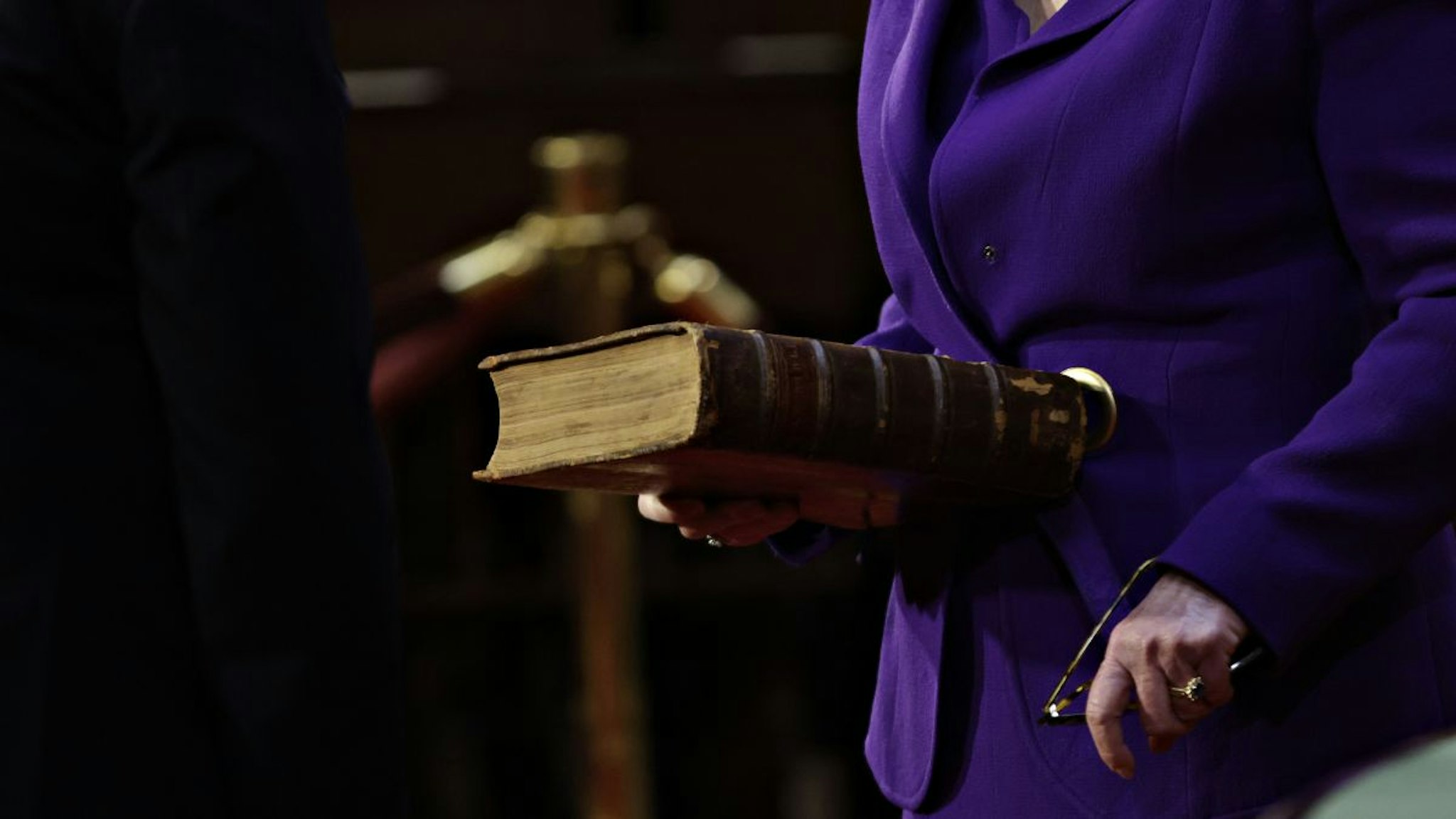 A Catholic Bible on loan from the U.S. Library of Congress is held before Senator Ed Markey, a Democrat from Massachusetts, not pictured, is ceremoniously sworn-in at the U.S. Capitol in Washington, D.C., U.S., on Sunday, Jan. 3, 2021.