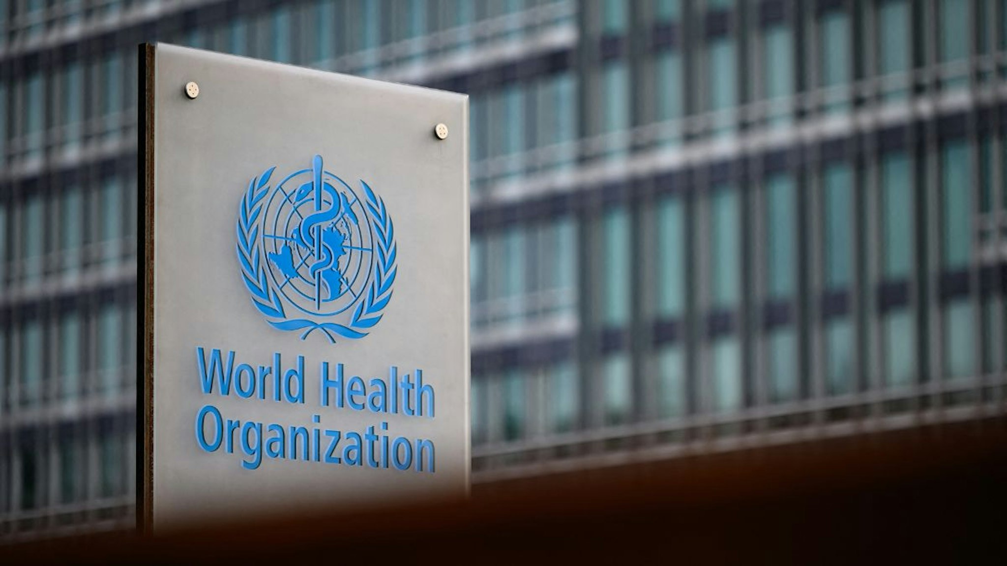 This photograph taken on December 7, 2021 shows a sign of the World Health Organisation (WHO) at their headquarters in Geneva.